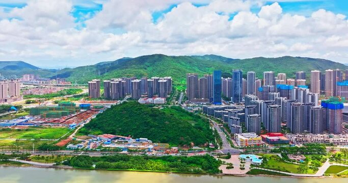 Aerial shot of Zhuhai city financial district skyline and natural scenery in Guangdong province, China. Creative category video without architectural logos