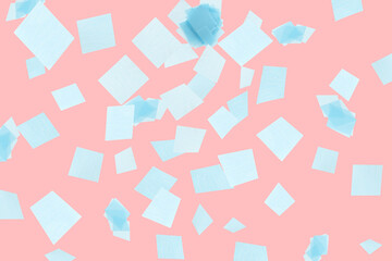Bright confetti falling on coral background. Party supply