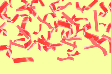 Bright red confetti falling on light yellow background