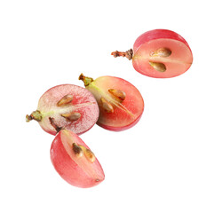 Halves of fresh grape falling on white background