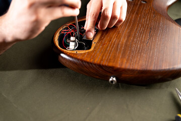 luthiers repairing electric bass