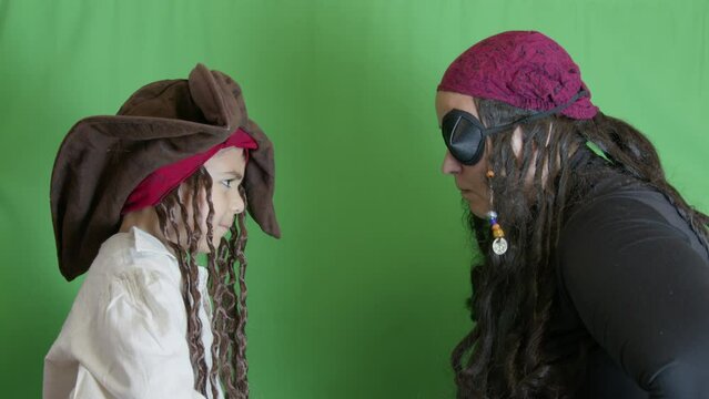 Pirates getting angry and fighting with cutlasses. Isolated on green background, slow motion. High quality 4k footage