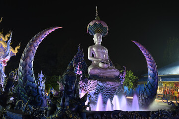 Night scene of Phra Upakut is a pearl white statue placed in the middle of a fountain under the...