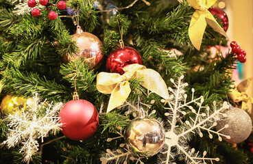 Blurry of Christmas and New Year's balls with beautiful decorations on the Christmas tree, soft light, beautiful background images and illustrations.
