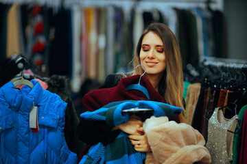 Happy Woman Holding Winter Coats Buying from Fashion Store. Indecisive customer shopping for new...