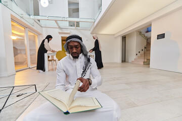 In the sacred month of Ramadan, an African American Muslim man engrossed in reading the Holy Quran...