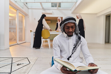 In the sacred month of Ramadan, an African American Muslim man engrossed in reading the Holy Quran...