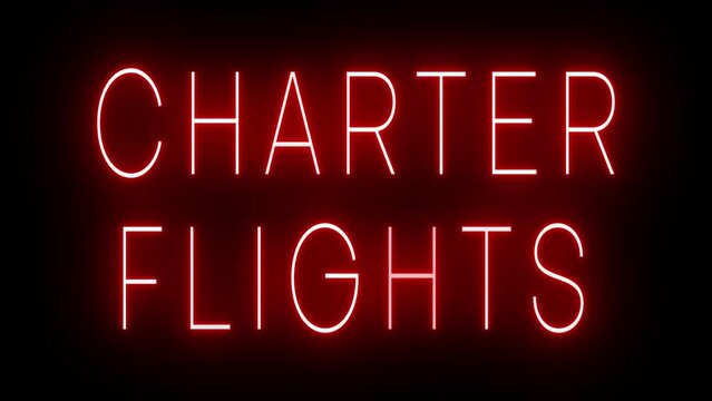 Flickering red retro style neon sign glowing against a black background for CHARTER FLIGHTS