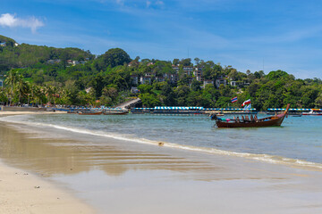 Patong Beach Phuket Thailand nice white sandy beach clear blue and turquoise waters and lovely blue skies with Palms tree