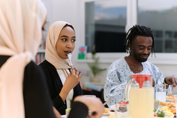 A traditional and diverse Muslim family comes together to share a delicious iftar meal during the sacred month of Ramadan, embodying the essence of familial joy, cultural richness, and spiritual unity