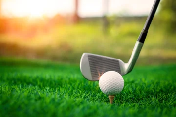 Schilderijen op glas Golf ball close up on tee grass on blurred beautiful landscape of golf background. Concept international sport that rely on precision skills for health relaxation. © Sittipol 