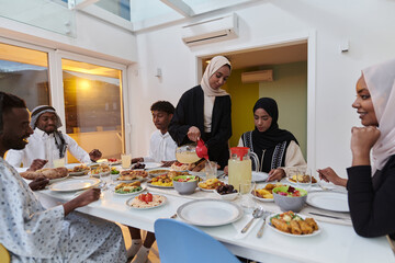 In the sacred month of Ramadan, a Muslim family joyously comes together around a table, eagerly awaiting the communal iftar, engaging in the preparation of a shared meal, and uniting in anticipation