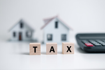 Concept of paying state property tax. Property Tax Wooden Blocks With A Miniature House. house...