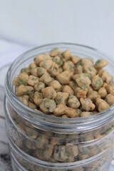 Indonesian snack called flour fried peas (kacang polong) in a jar on the table