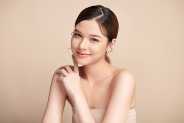 Beautiful young asian woman with clean fresh skin on beige background, Face care, Facial treatment, Cosmetology, beauty and spa, Asian women portrait.