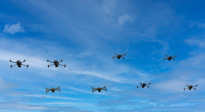 Group of surveillance drones in front of blue sky background
