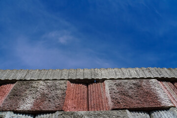 concrete block wall with blue sky background