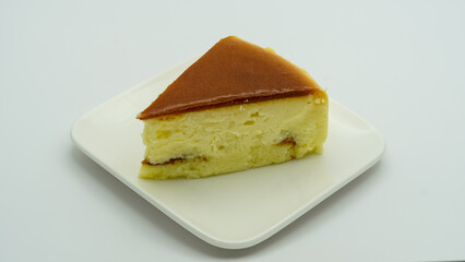 Slice of plain cheesecake on white plate