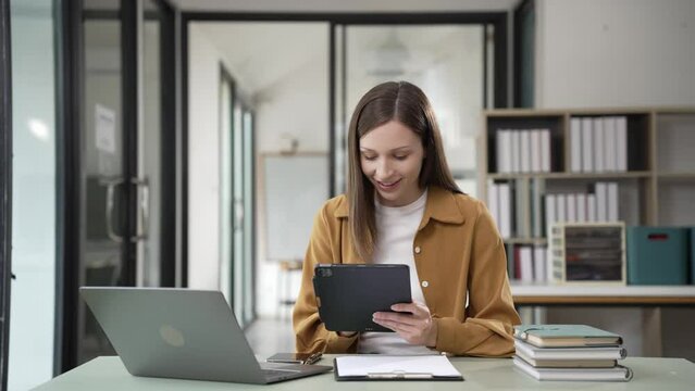 Remote career smiling woman using laptop at home Young freelance woman working with laptop at home office. High quality 4k image, online working concept.