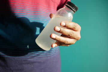 holding dirty bottle of water 