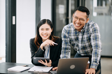 Female discussing new project with male colleague. Young woman talking with young man in office.