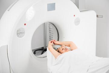 Medical computed tomography or MRI scanner. Woman patient lying on couch, waiting for doctor....