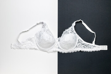 A beautiful white bra on a black and white background.