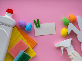 Happy Easter and cleaning concept. Detergent with Easter decoration on pink background with copy...