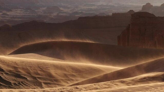 Sand blowing over dunes in wind, sandstorm in Gobi desert, Mongolia
