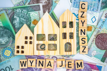 Polish word "czynsz and wynajem" rent with wooden house Polish zloty banknote background currency Housing concept