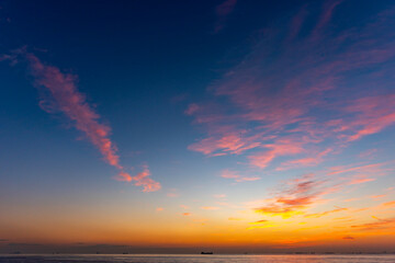 Sunset sky. Beautiful cloudy sunset sunrise sky. Orange and blue colors. Fiery orange sunset sky.