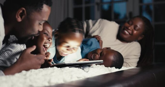 Happy, night and a black family with a tablet on the bed for tickling, playful and laughing at a show. Home, relax and African parents with children, fun and technology in the dark for a cartoon