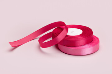 Satin ribbon for holiday packaging in a roll, close-up.