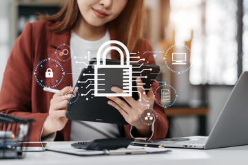 Cybersecurity and privacy concepts to protect data. Lock icon and network security technology. women protecting personal data on smartphone tablet, virtual screen interfaces. In office