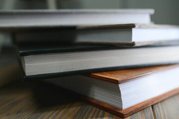 photobooks stacked on top of each other. the concept of making books and albums from photos. services of a professional photographer and printing house
