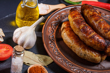Fried barbecue sausages with vegetables and different spices, fried sausages, junk fried food