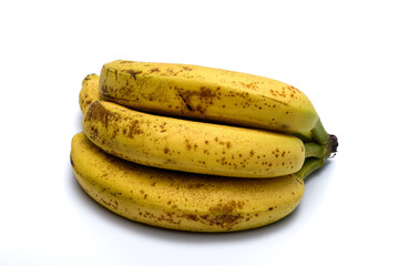 Dojrzałe banany w skórce leżą izolowane na białym tle © Paweł Kacperek