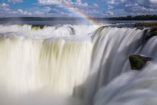 Waterfall details with rainbow at Devil's Throat at Iguazu Waterfalls in Brazil