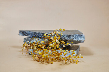 blue marble podium or stone beauty with yellow and white gypsophila. Product promotion Beauty...