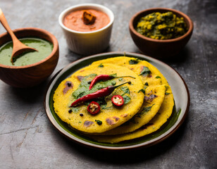 makki di roti with sarson ka saag, popular punjabi main course recipe in winters made using corn breads mustard leaves curry. served over moody background