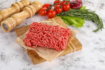 Raw minced beef meat on cutting board