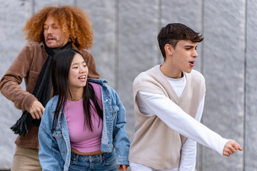 Animated young adults in mid-dance, expressing joy and energy against an urban backdrop, lost in the moment