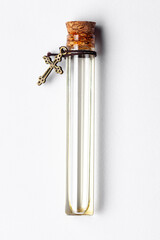 Top-down view of a glass vial containing pale yellow essential oil for cosmetics and natural...