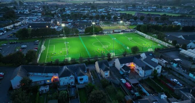  The floodlights on the football field are switched on in 4k