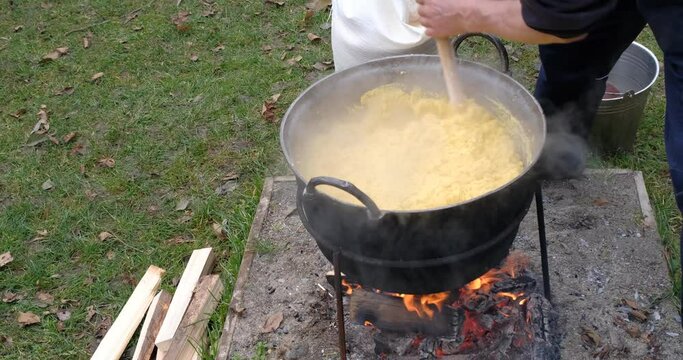 Preparation of polenta in a cauldron on the open fire