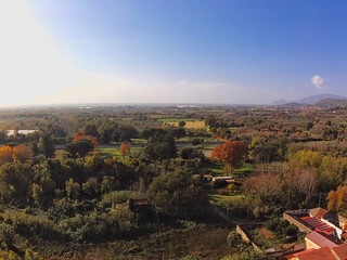 aerial view of autumn colored plain countryside crossed by an old street
