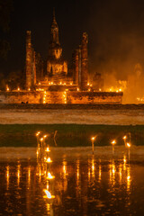 Fototapeta na wymiar Wat Mahathat illuminated by candlelight.