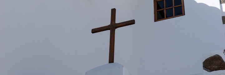 Panoramic image. Wooden cross at a white church. Spain