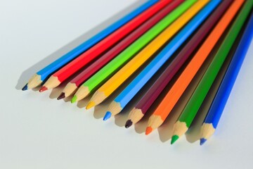 Lots of colored pencils on white background 