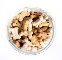 Top view of bones for dogs, delicacy treats in jar isolated on white background.